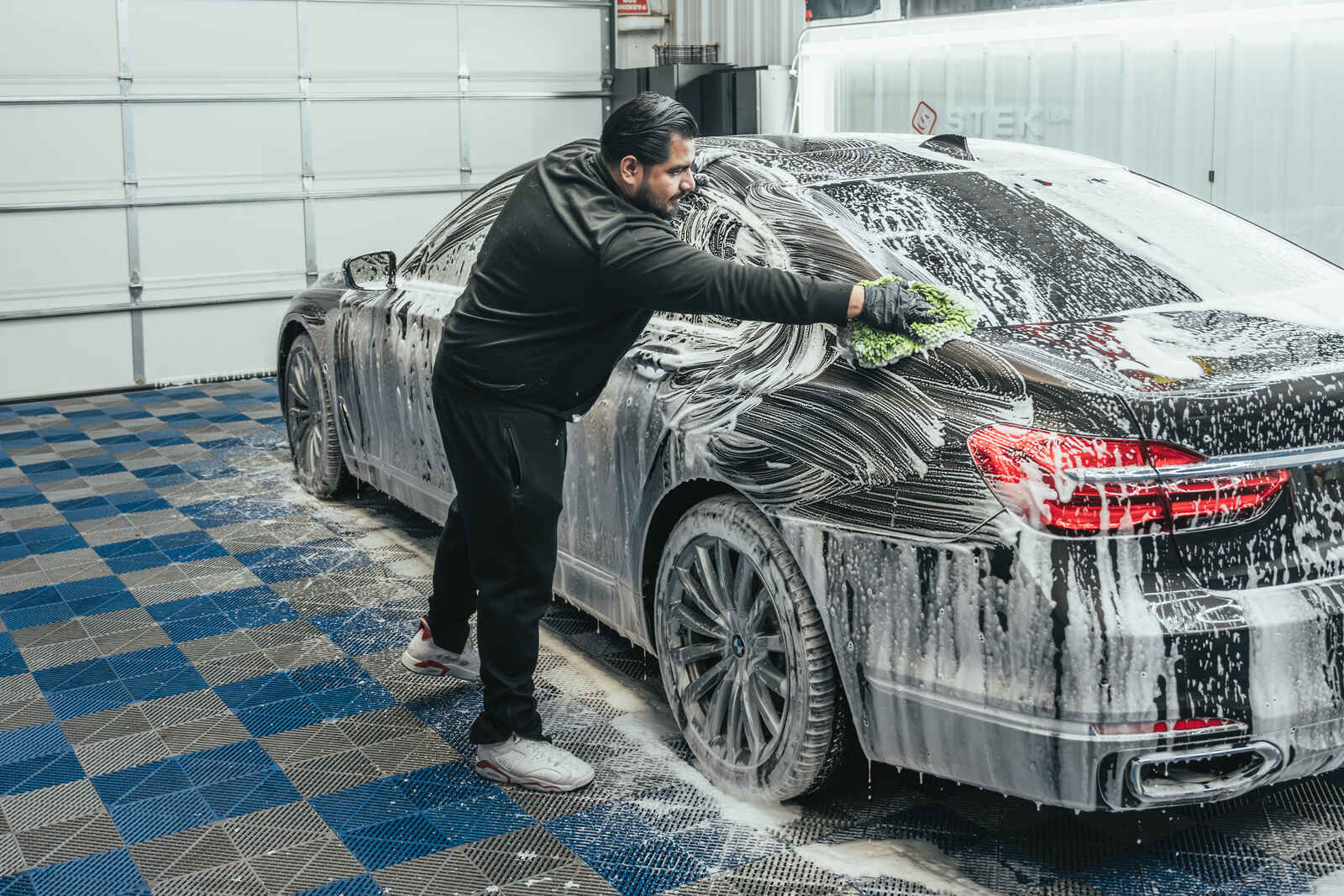 AutoPro DFW technician performing detailed auto cleaning on a car interior and exterior.