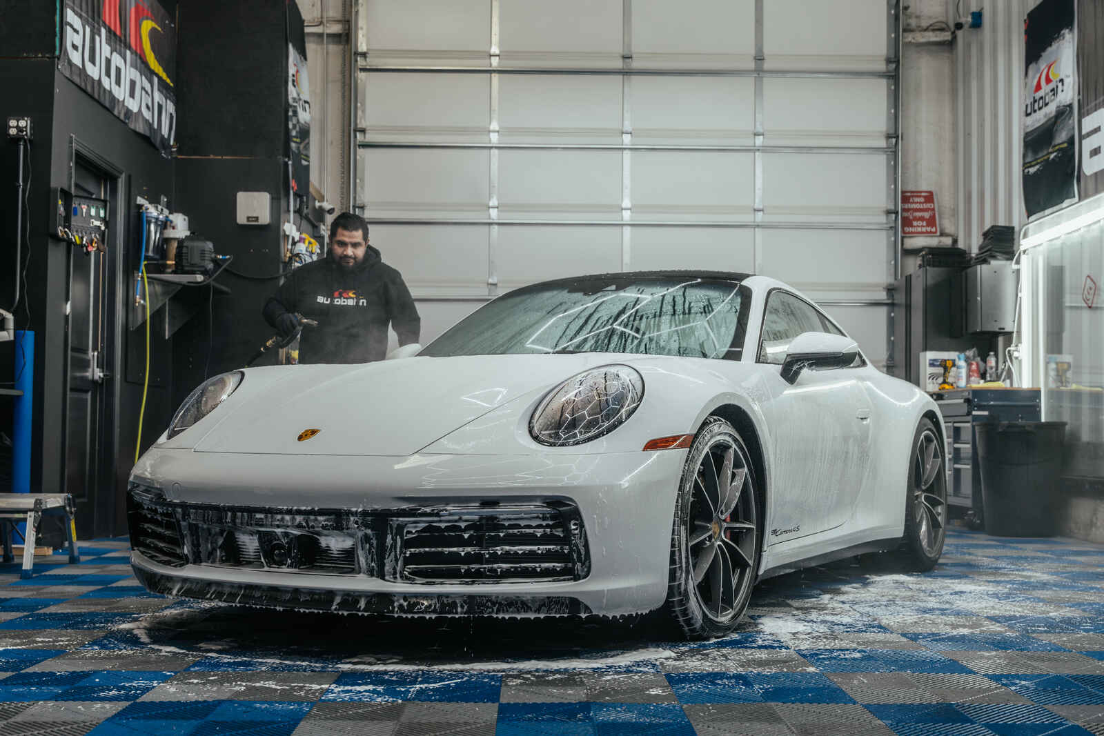 Worker is performing a hand car wash in Fort Worth, TX | AutoPro DFW on Porsche 911.